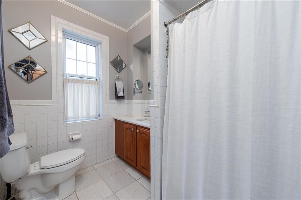 608 Blackburn Road Sewickley, PA 15143 - Photo 18 of 24 The second-floor full bathroom is surrounded in decorative white tile and has a granite-topped vanity.