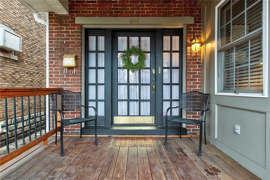 Wood front porch offers outside space out front to greet guests.