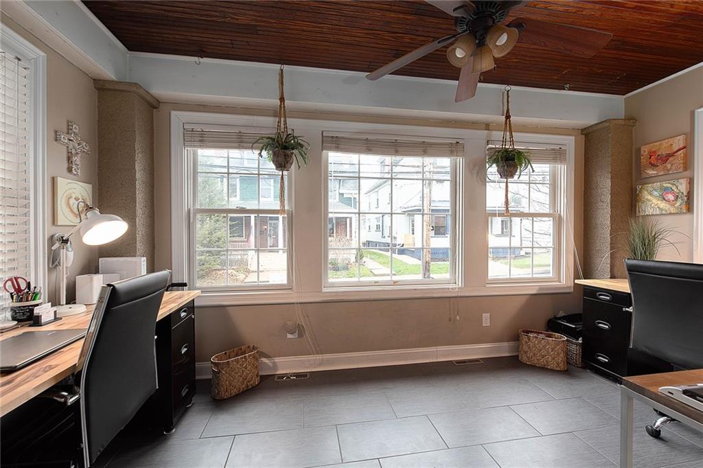 An office surrounded by windows is the perfect addition to the front of the home.