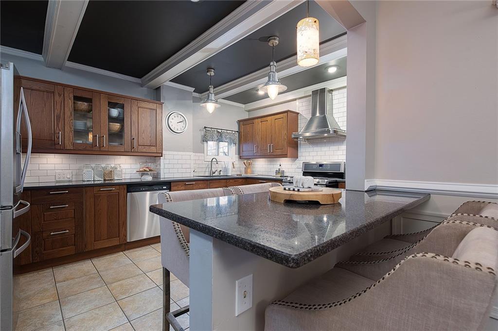 608 Blackburn Road Sewickley, PA 15143 - Photo 10 of 24 An eat-in kitchen peninsula adds extra seating for family meals.