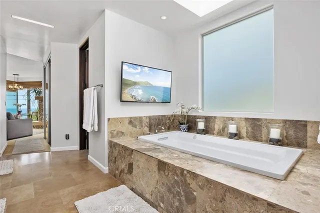 a bathroom with a granite countertop toilet a sink a mirror and shower