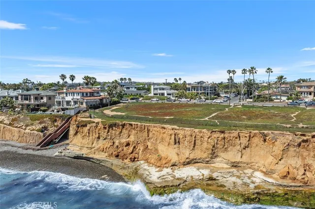 a living room with furniture a chandelier and a potted plant