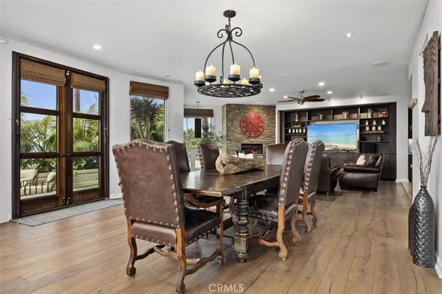 a kitchen with kitchen island a dining table chairs sink and cabinets