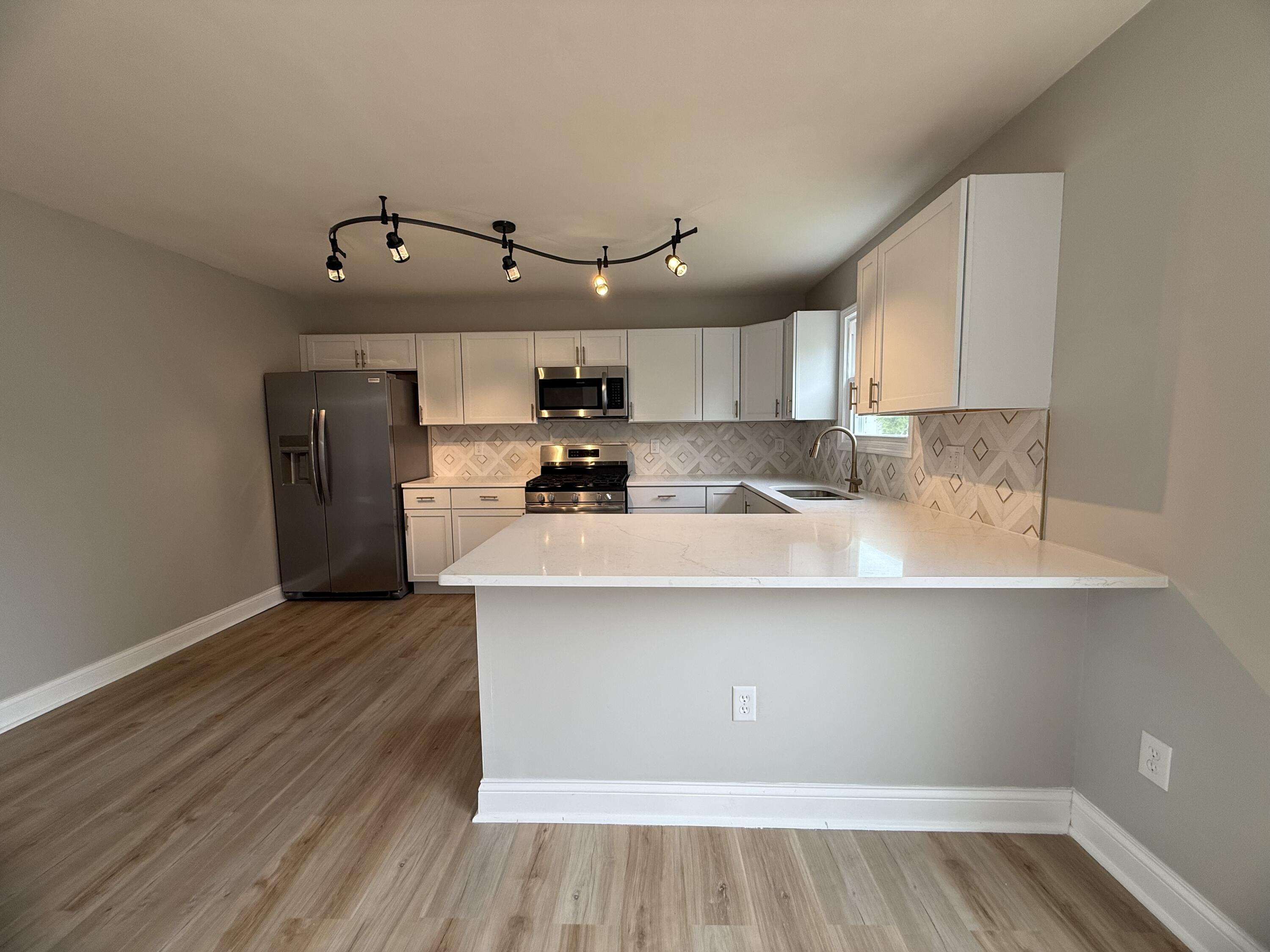 15895 Sherman Street Lowell, IN 46356 - Photo 12 of 36 a kitchen with a sink a microwave and cabinets