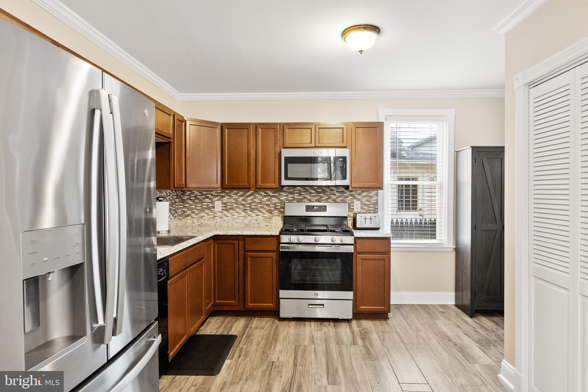 511 Ash Street Delanco, NJ 08075 - Photo 11 of 30 a kitchen with stainless steel appliances granite countertop a refrigerator and a stove top oven