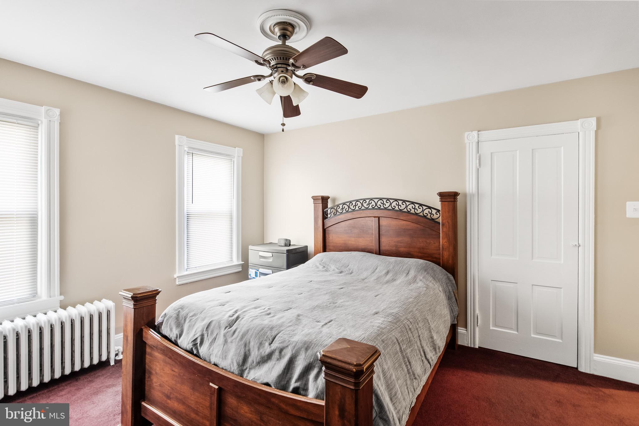 511 Ash Street Delanco, NJ 08075 - Photo 22 of 30 a bedroom with a bed and a chandelier