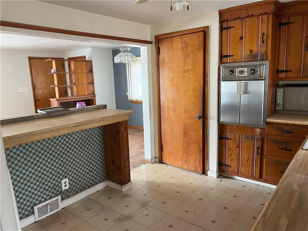 756 McLean Street Rochester, PA 15074 - Photo 8 of 35 a view of a kitchen from the hallway