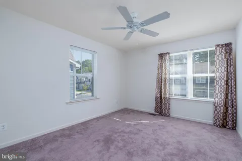 an empty room with a empty space and windows