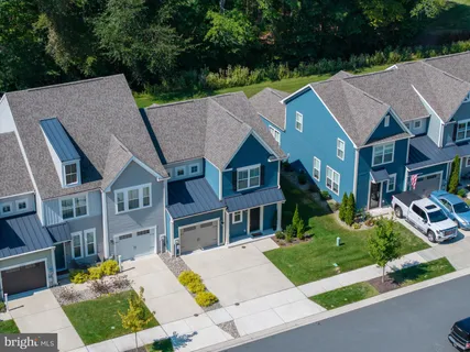 a aerial view of a house next to a yard