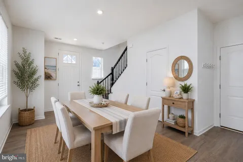 a view of a dining room with furniture and a potted plant
