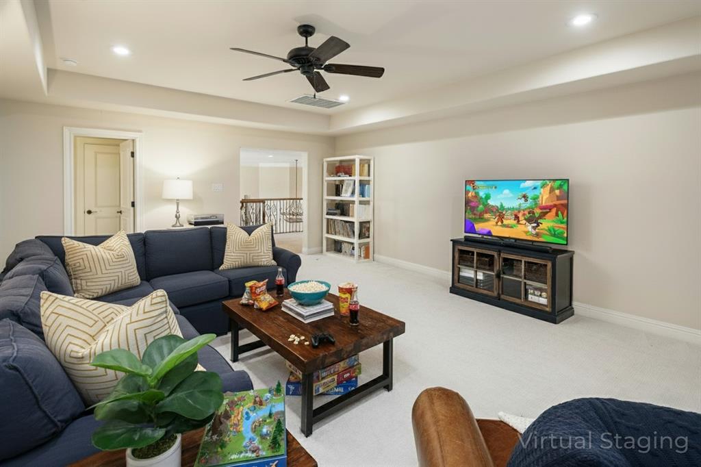 1715 San Jacinto Drive Allen, TX 75013 - Photo 18 of 33 a living room with furniture a flat screen tv and a wall painting