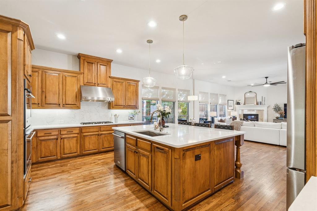1715 San Jacinto Drive Allen, TX 75013 - Photo 5 of 33 a kitchen with stainless steel appliances granite countertop a sink a stove and a refrigerator