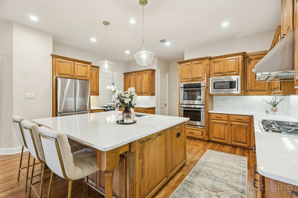 1715 San Jacinto Drive Allen, TX 75013 - Photo 6 of 33 a kitchen with stainless steel appliances granite countertop a table chairs sink refrigerator and cabinets