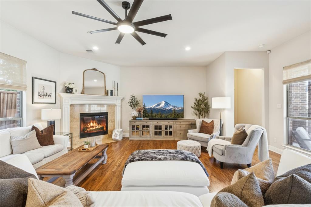 1715 San Jacinto Drive Allen, TX 75013 - Photo 9 of 33 A corner fireplace adds charm and comfort to the family room, making it the perfect space to relax or entertain.
