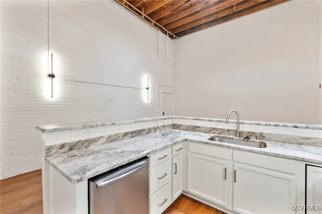 a utility room with a sink and dishwasher