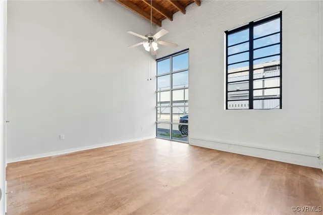 an empty room with windows and closet