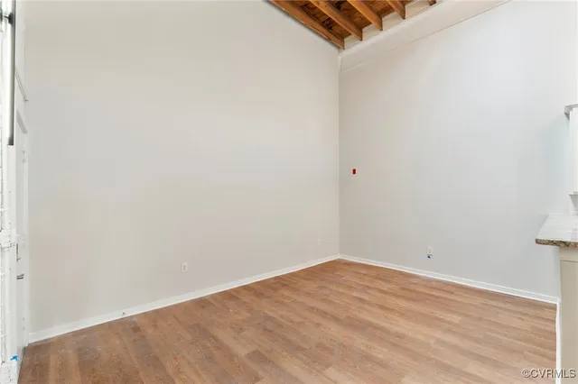 a view of a room with wooden floor