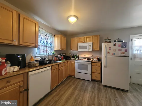 a kitchen with a white cabinets and white appliances