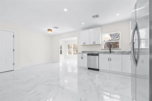 a white kitchen with cabinets and a sink