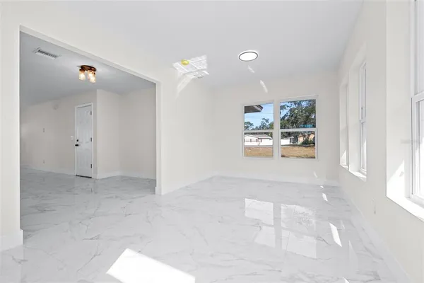 a view of an empty room with a window