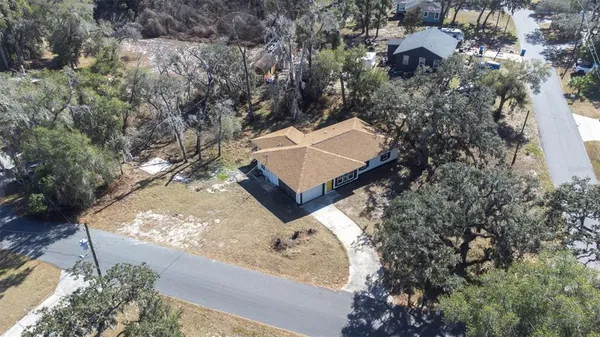 an aerial view of house with yard