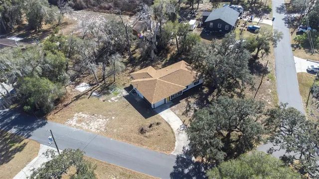 an aerial view of house with yard