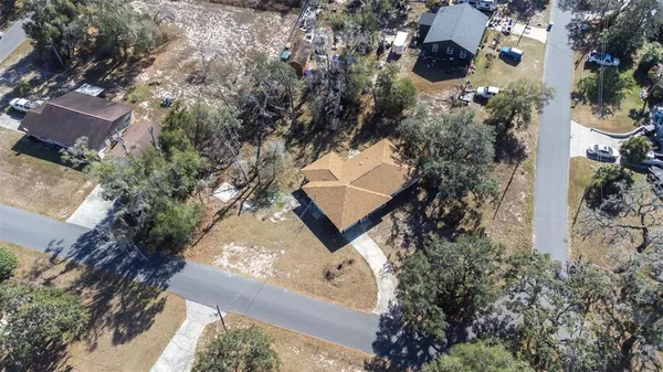 an aerial view of a house with a yard and garden