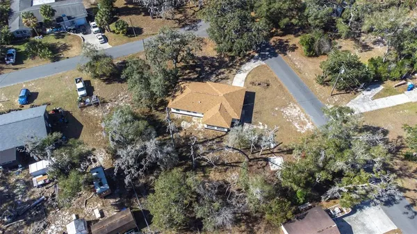a view of a house with a yard and a tree