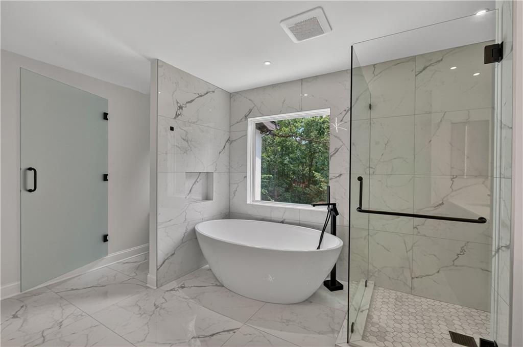 4610 West Morton Road Alpharetta, GA 30022 - Photo 33 of 53 a spacious bathroom with a bathtub and shower