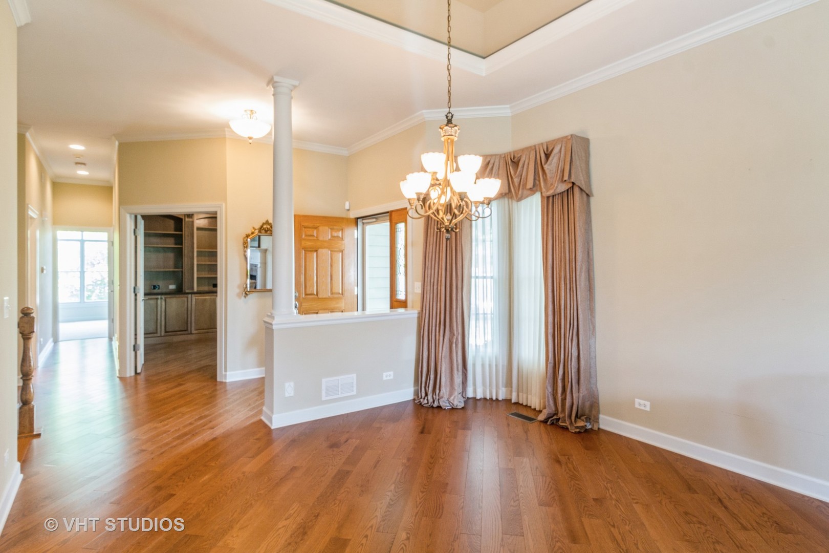1 Sugar Maple Court Lake In The Hills, IL 60156 - Photo 3 of 29 an empty room with wooden floor and windows