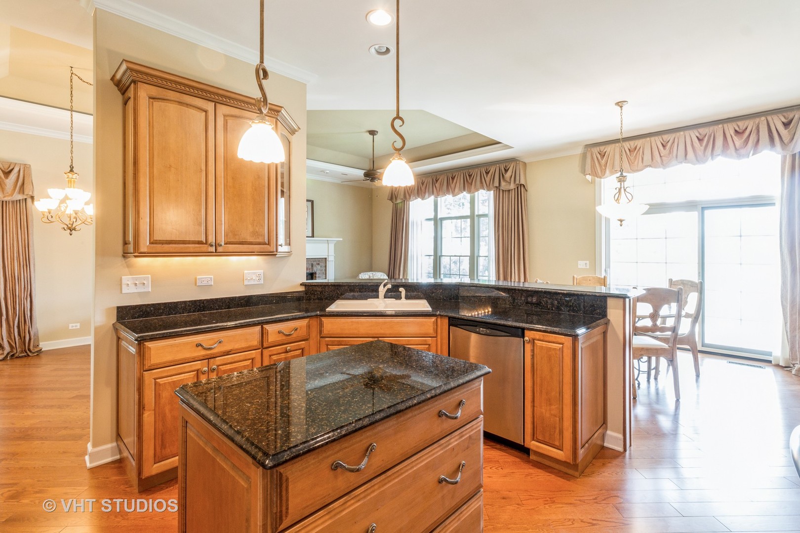 1 Sugar Maple Court Lake In The Hills, IL 60156 - Photo 7 of 29 a kitchen with granite countertop a stove a sink a dining table and chairs