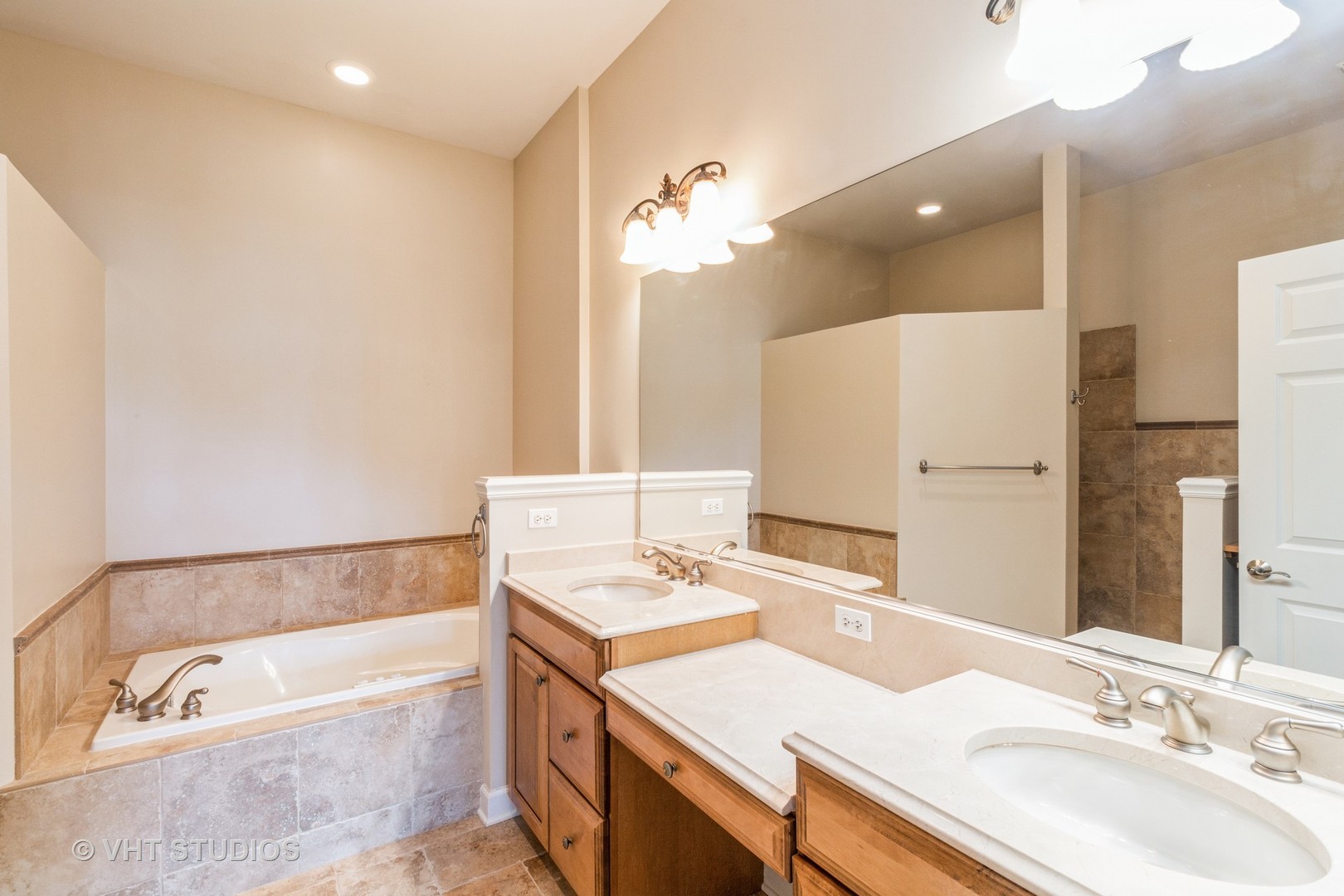 1 Sugar Maple Court Lake In The Hills, IL 60156 - Photo 10 of 29 a bathroom with a tub a double vanity sink and a mirror