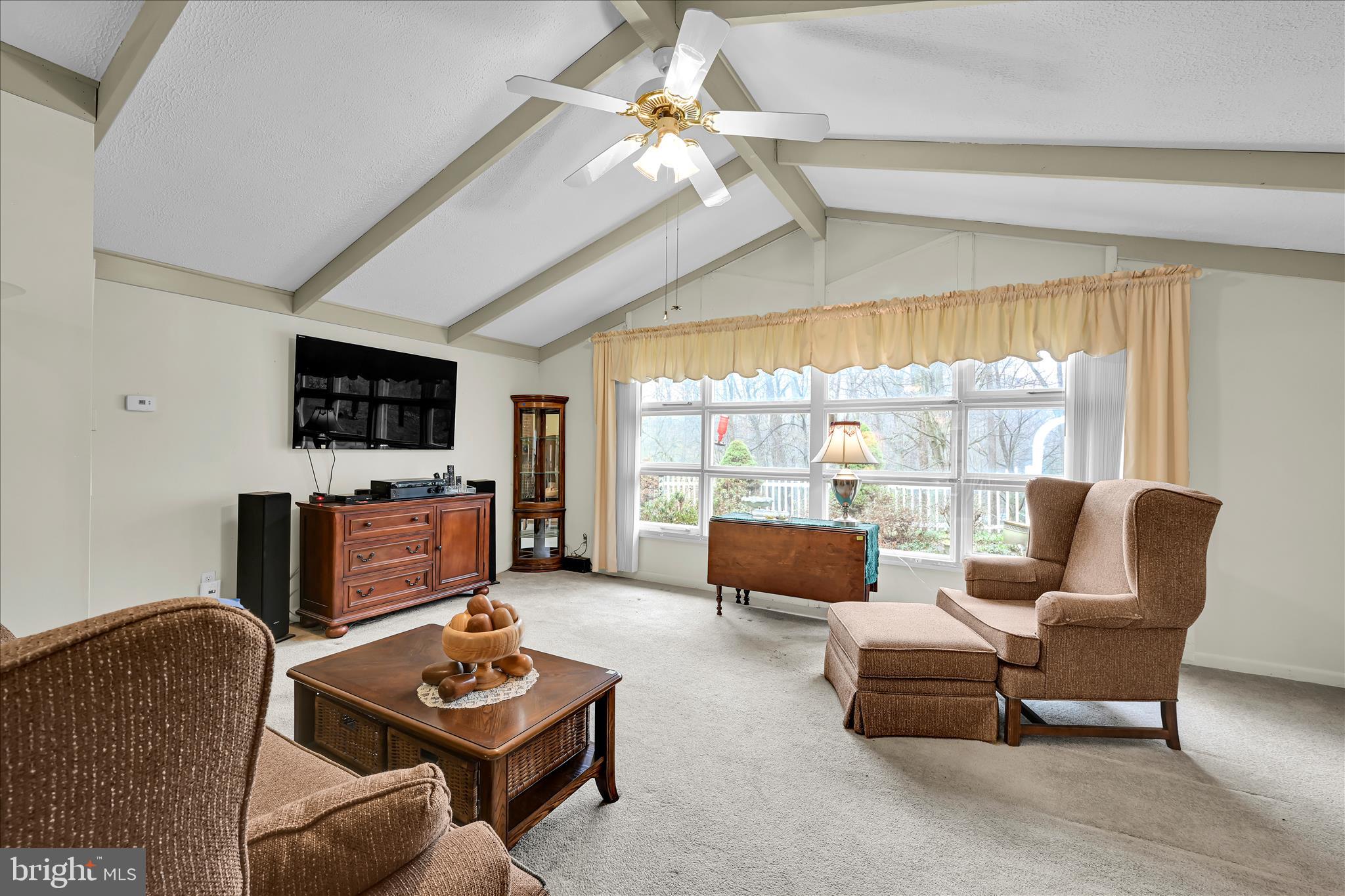 1534 Benton Hollow Road Drumore, PA 17518 - Photo 18 of 50 a living room with furniture a flat screen tv and a floor to ceiling window