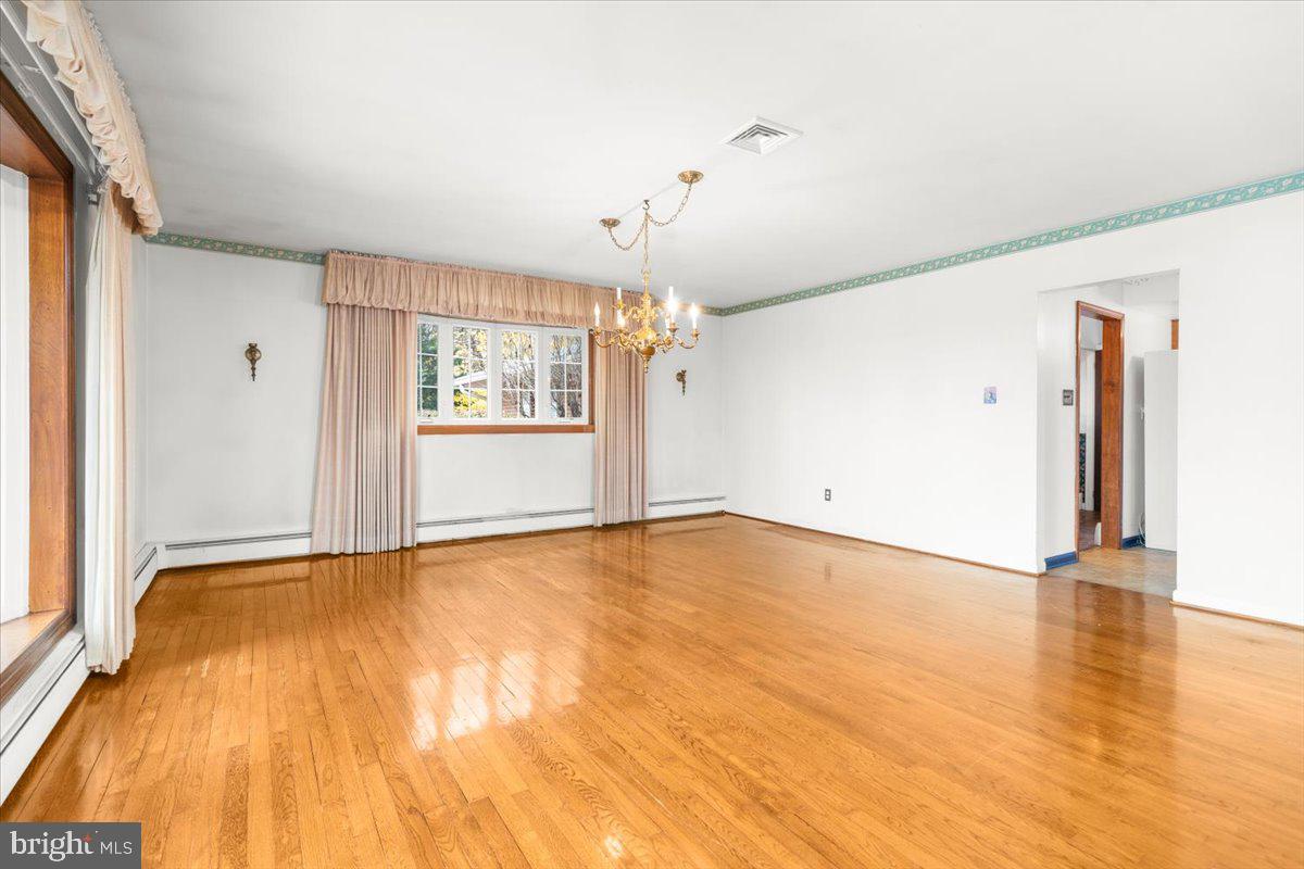 935 Ebelhare Road Pottstown, PA 19465 - Photo 22 of 52 a view of an empty room with wooden floor and a window