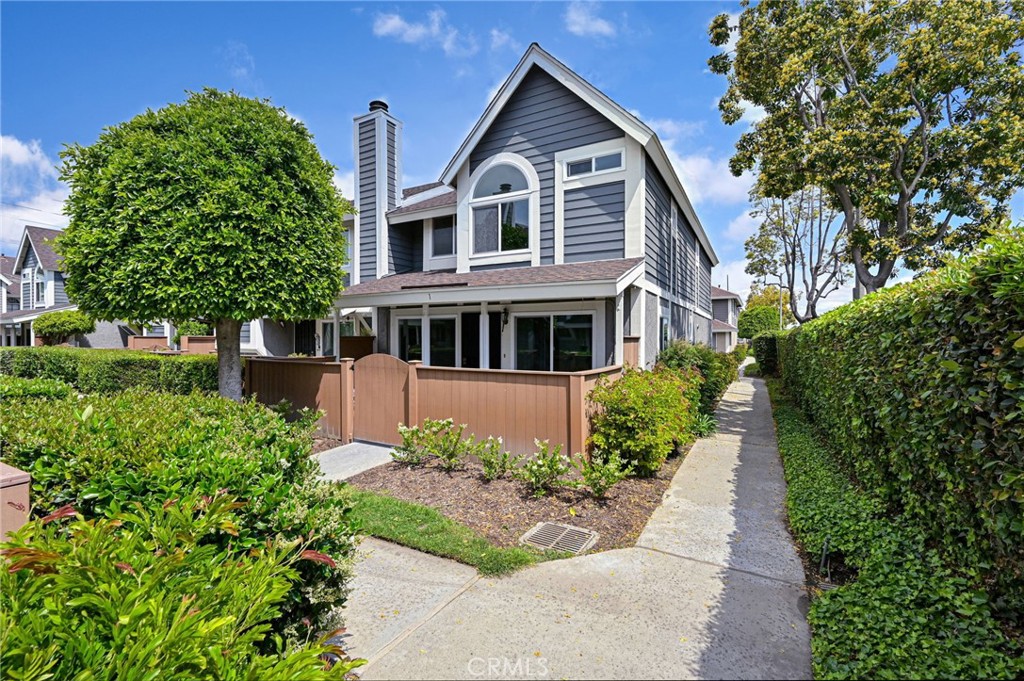 a front view of a house with a yard and trees