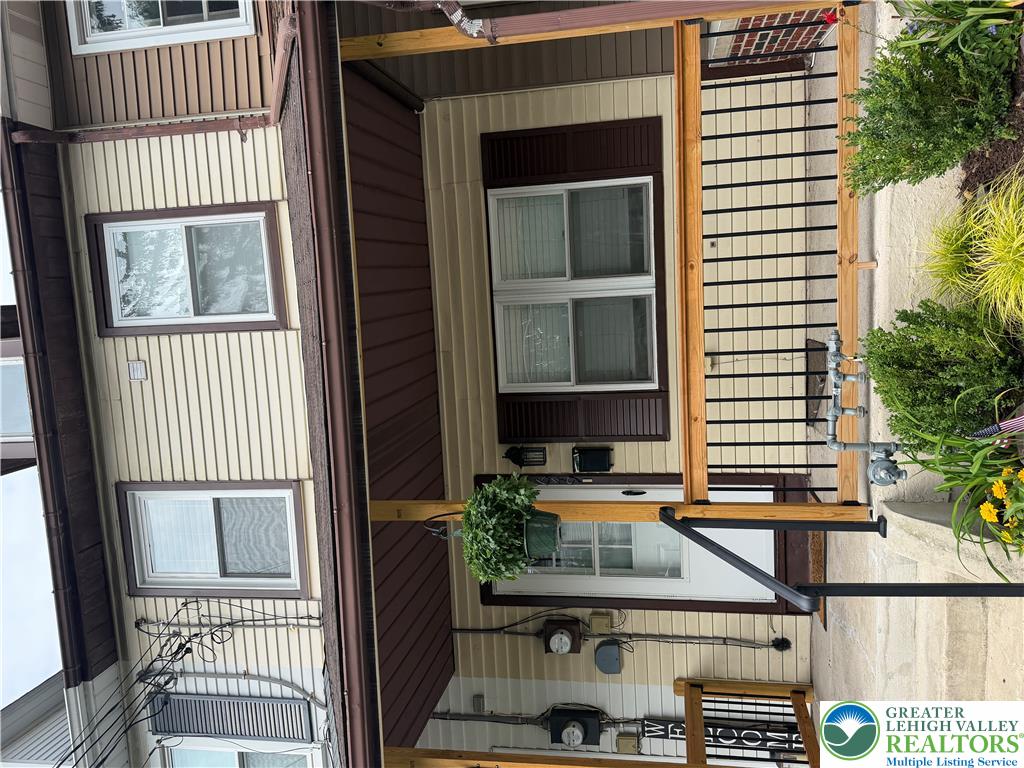 An inviting covered front porch welcomes visitors to this classic multi-level residence.
