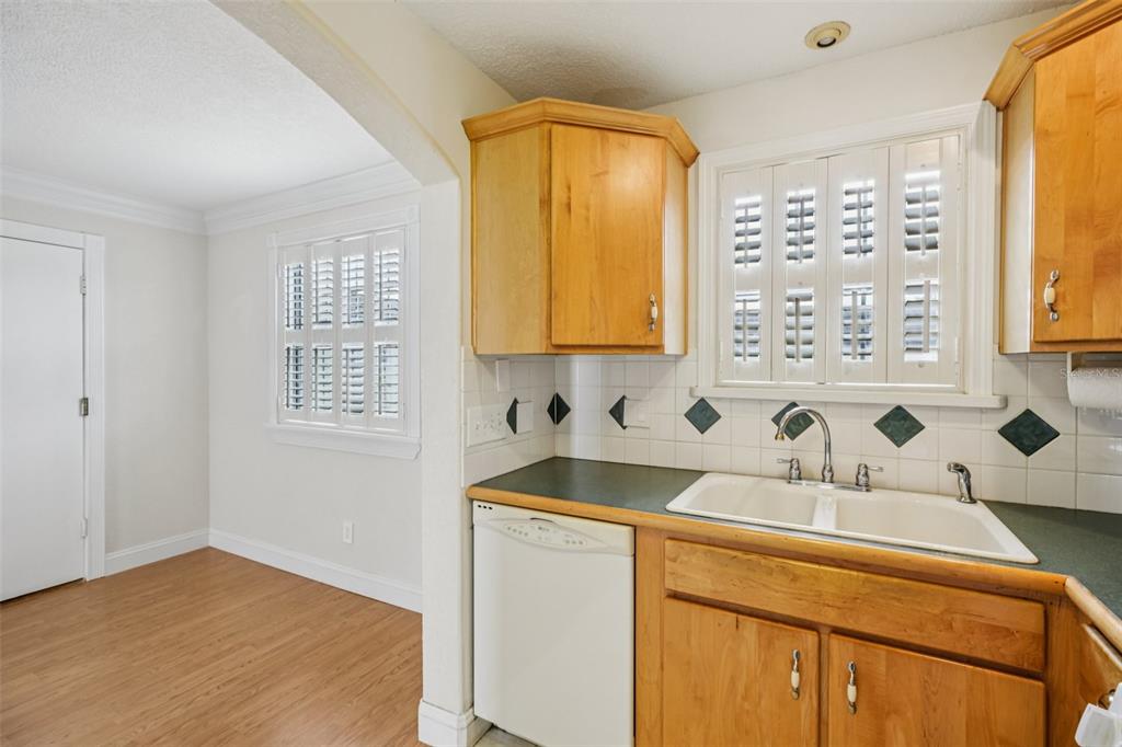 1500 Gay Road, Unit 21C Winter Park, FL 32789 - Photo 11 of 27 a kitchen with a sink a window and cabinets