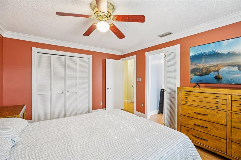 1500 Gay Road, Unit 21C Winter Park, FL 32789 - Photo 13 of 27 a bedroom with a bed and a dresser