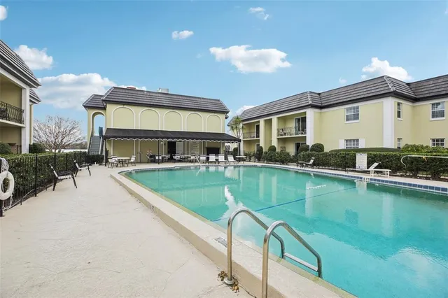 a view of a house with swimming pool and sitting area