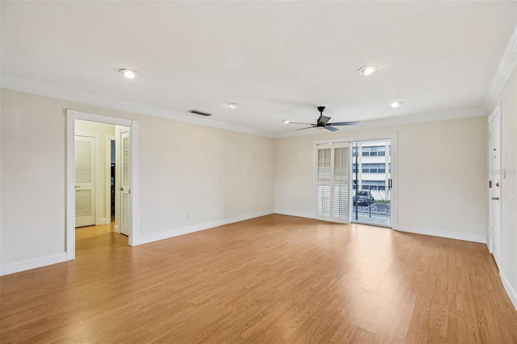 1500 Gay Road, Unit 21C Winter Park, FL 32789 - Photo 8 of 27 a view of an empty room with wooden floor and a window