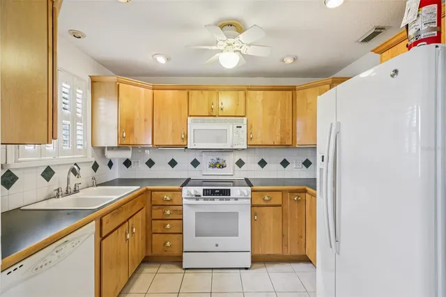 a kitchen with a stove sink and cabinets
