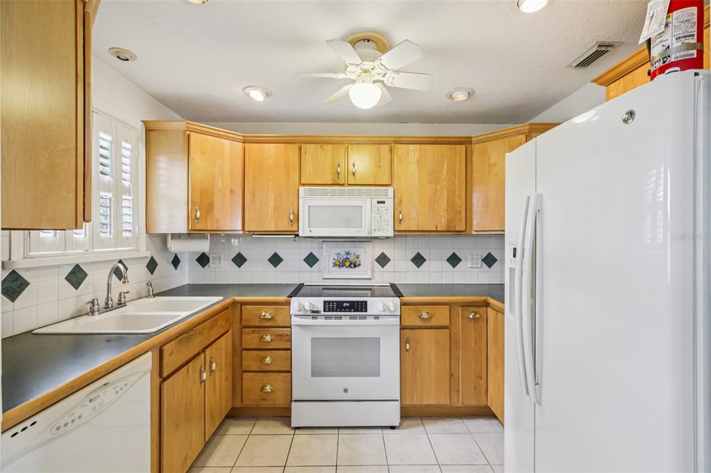 1500 Gay Road, Unit 21C Winter Park, FL 32789 - Photo 10 of 27 a kitchen with a stove sink and cabinets