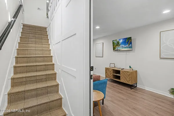 a view of staircase with furniture and wooden floor