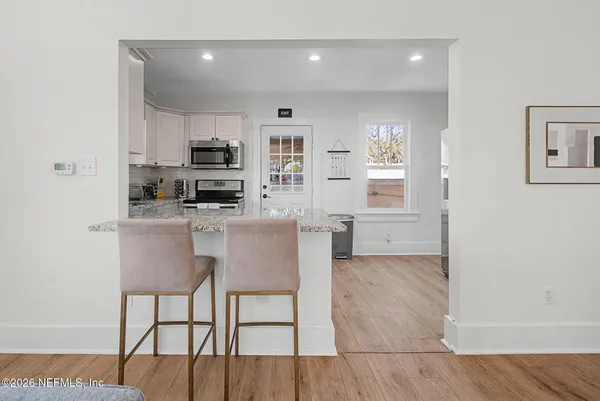 a kitchen with stainless steel appliances a refrigerator and a stove top oven