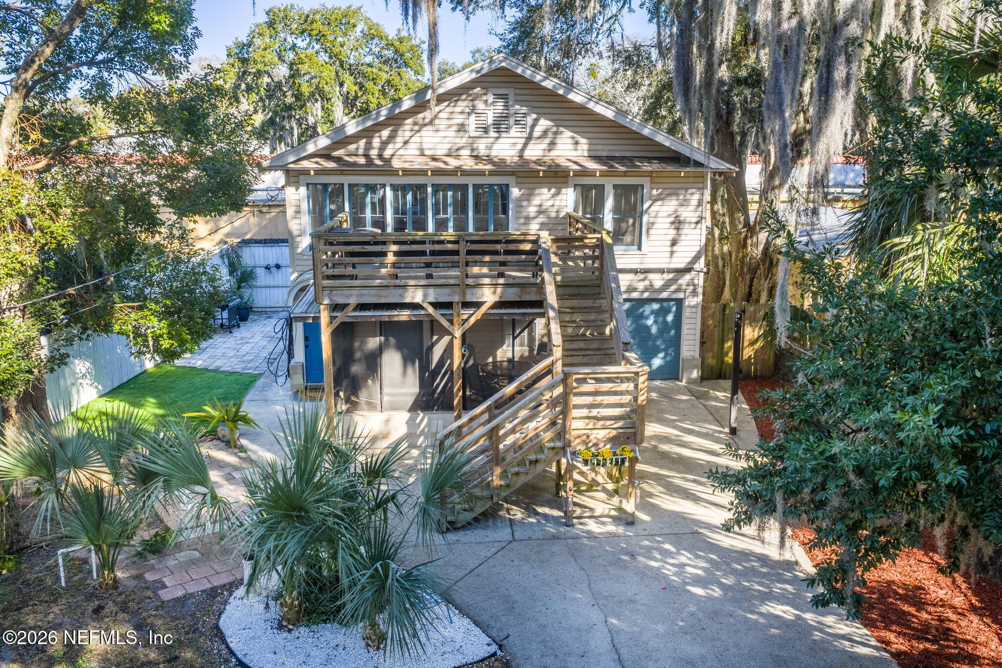 16 Myrtle Avenue St. Augustine, FL 32084 - Photo 2 of 47 a view of a small yard in front of a house with large trees and plants