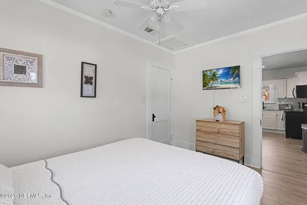 a bedroom with a bed and a chandelier