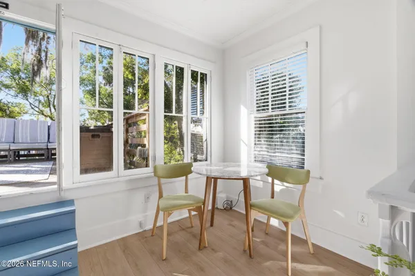a view of a dining room with furniture and windows