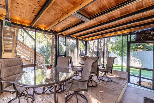 a view of a dining room with furniture wooden floor and a potted plant