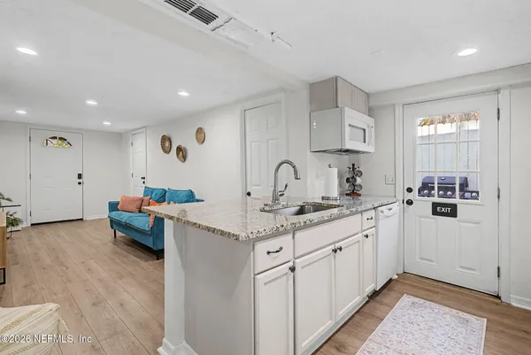 a kitchen with sink and cabinets