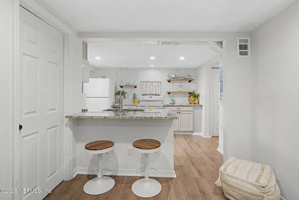 a kitchen with kitchen island stainless steel appliances a sink and a refrigerator